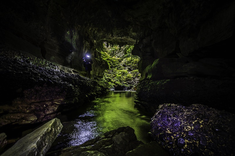 Photograph of caver in Mangarongapu Cave entrance