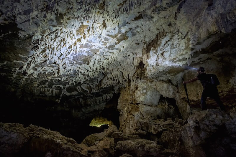 Photograph of caver in large cavern - Down to Earth
